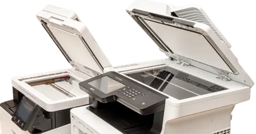 Two high-performance office copiers with open scanner lids showcasing modern design